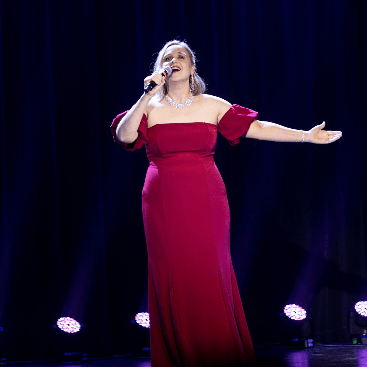 Photo of Lady in red dress singing