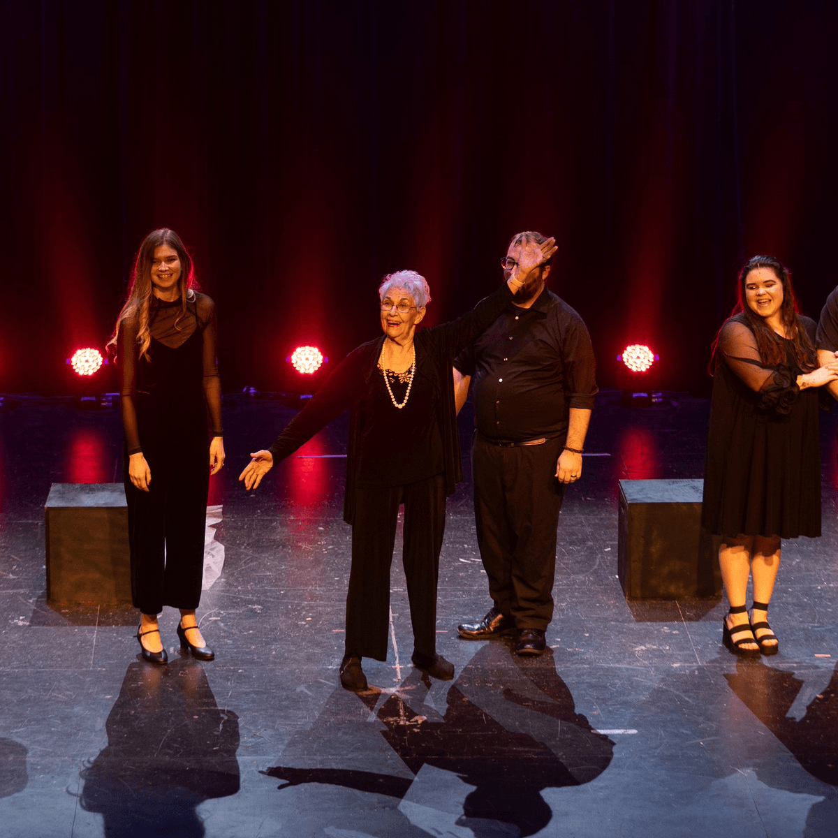 Photo of six performers singing