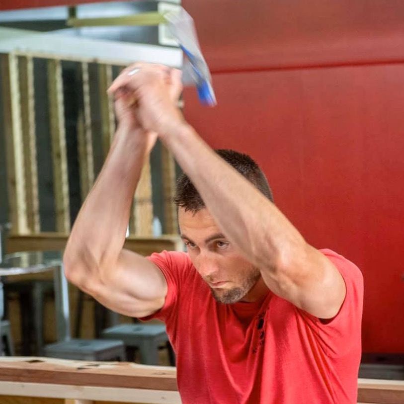 guy throwing axe in downtown