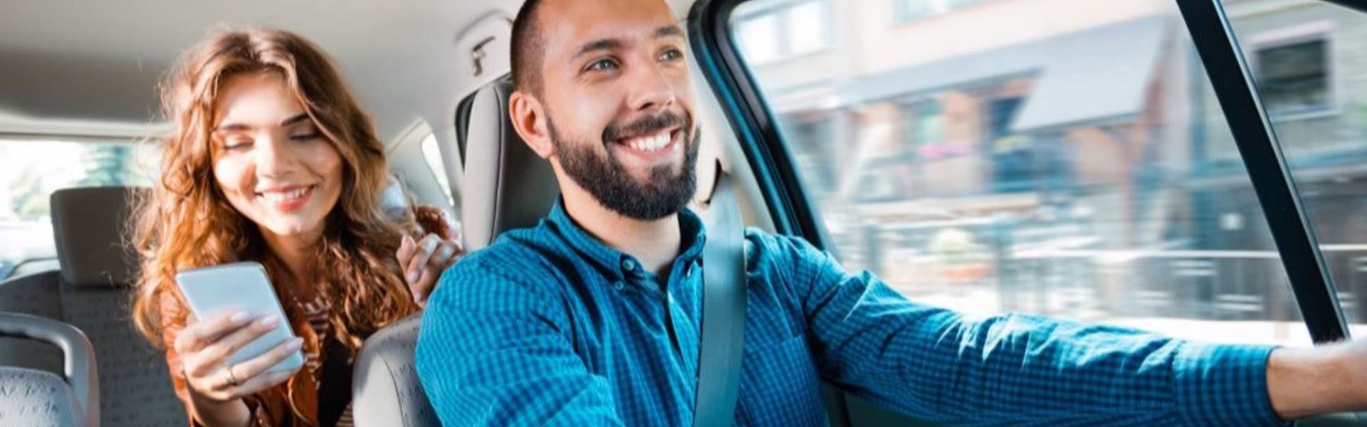 Woman rides in the back seat of an Uber.