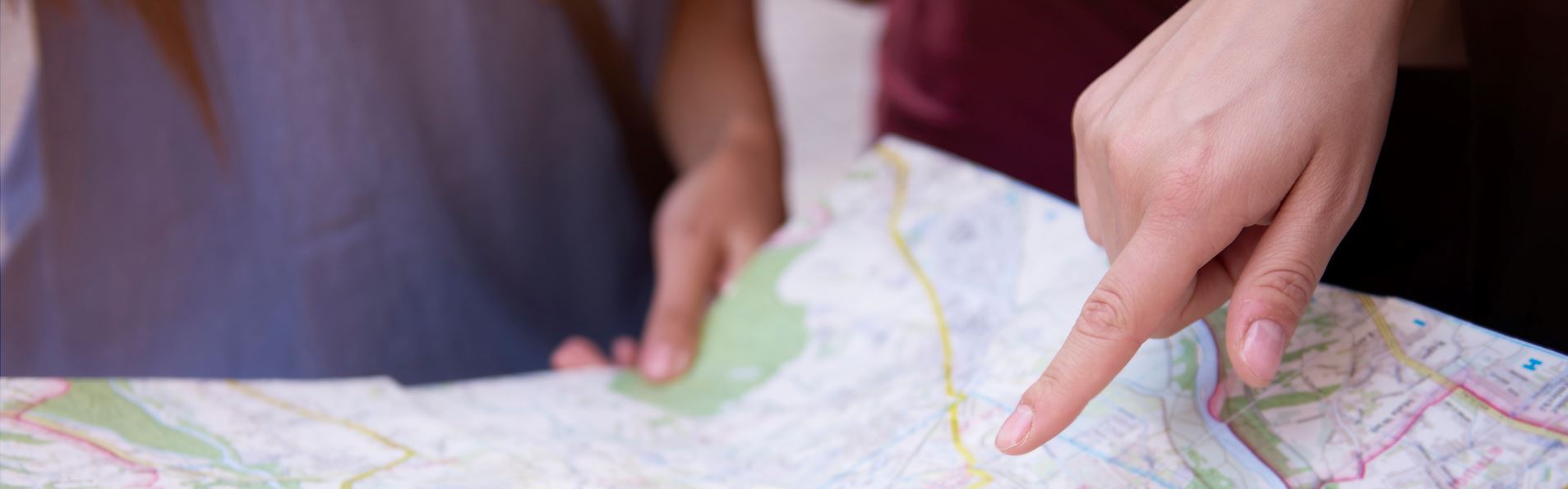 Hand pointing to map