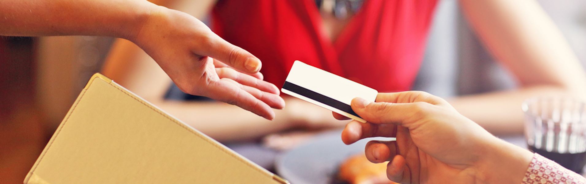 Lady pays for meal by credit card