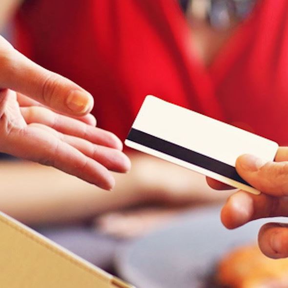 Lady pays for meal by credit card