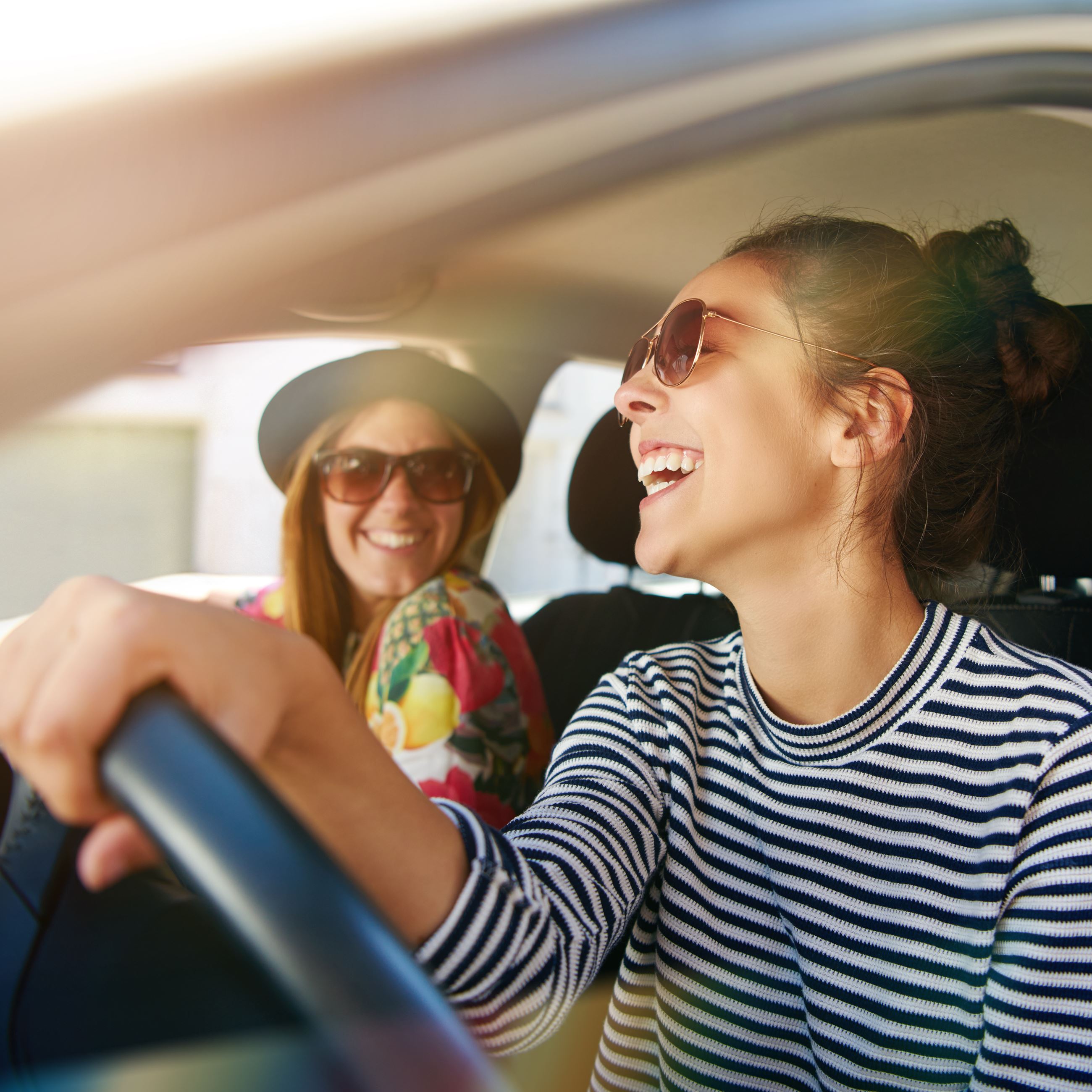 Two girls having fun driving car