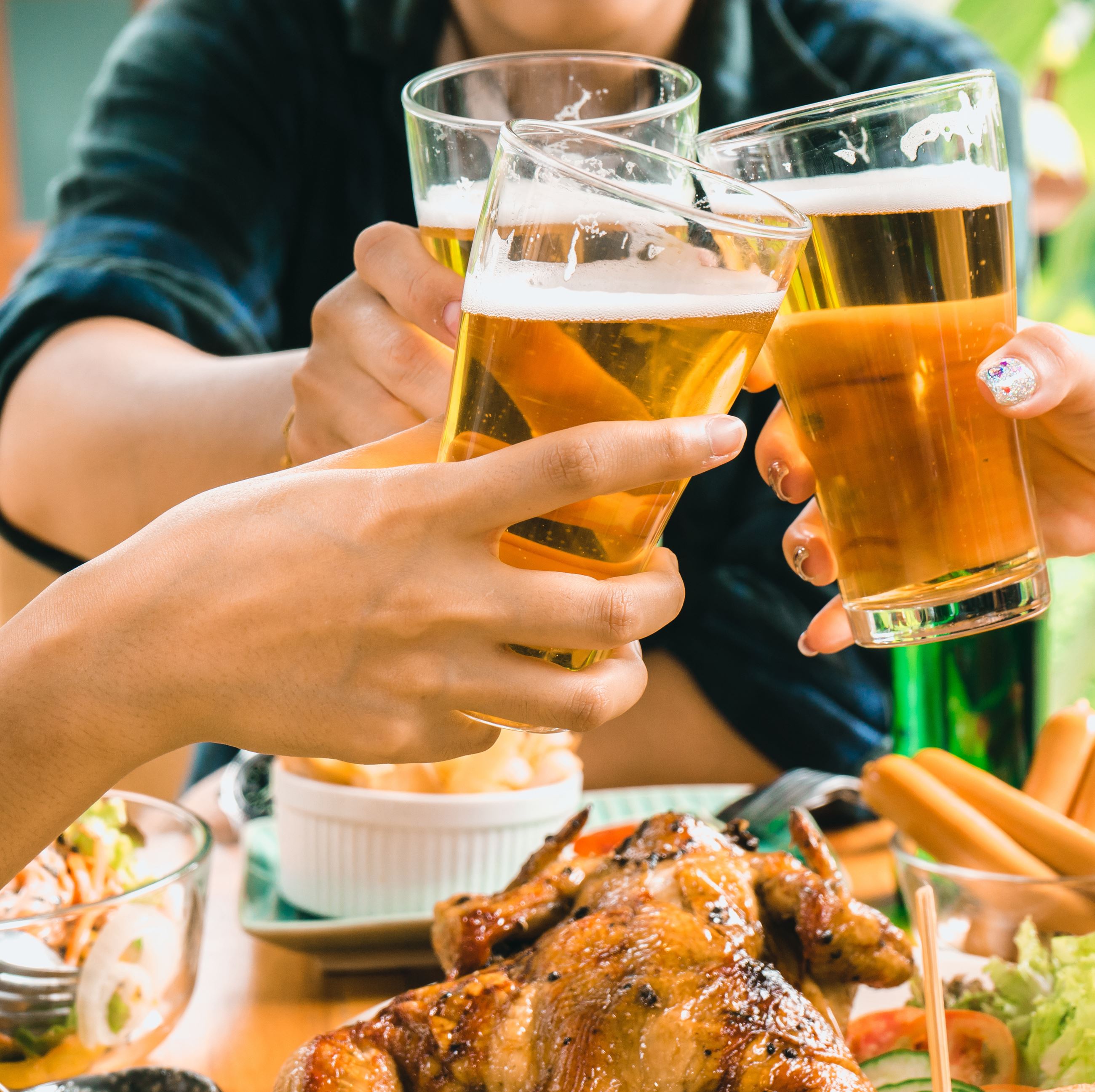 friends toasting with beer and food