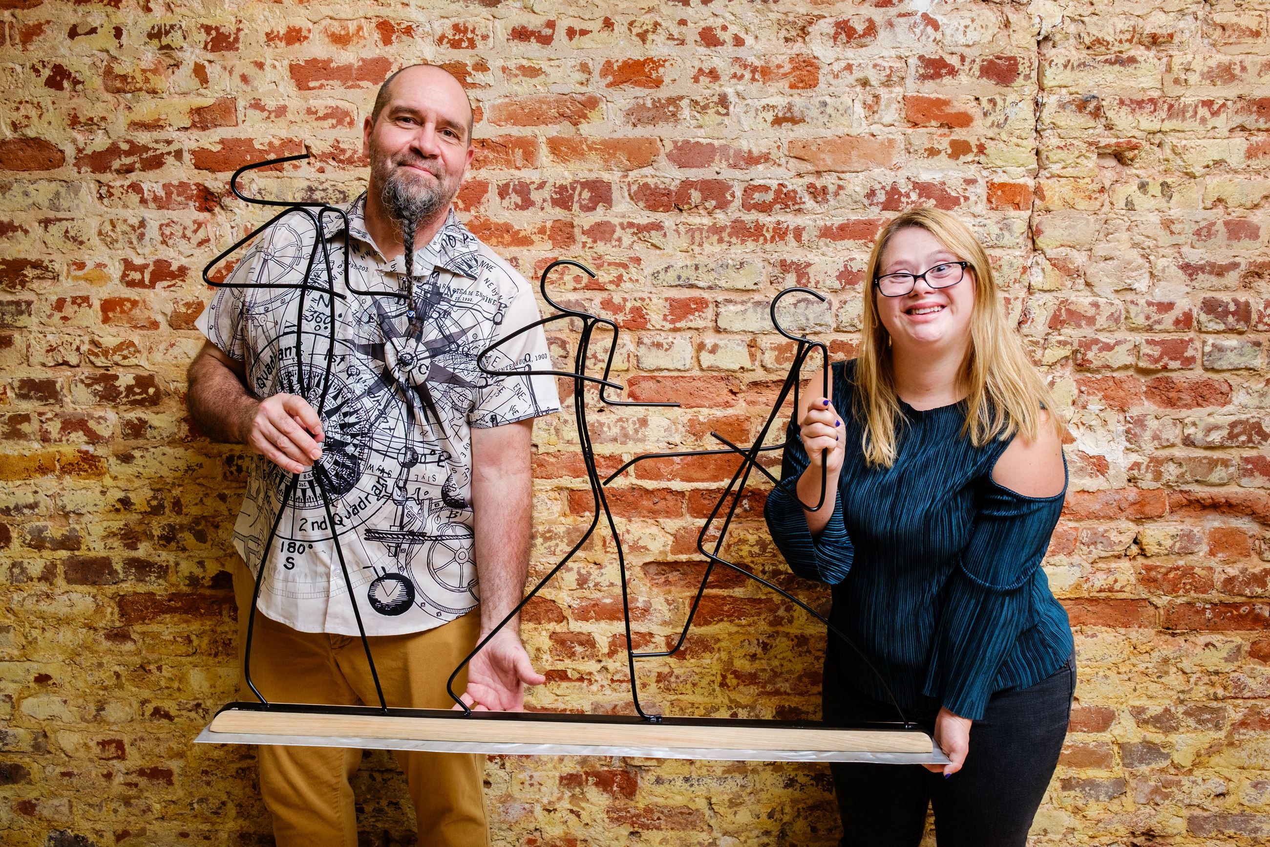 Charles and Alex holding raffle art piece