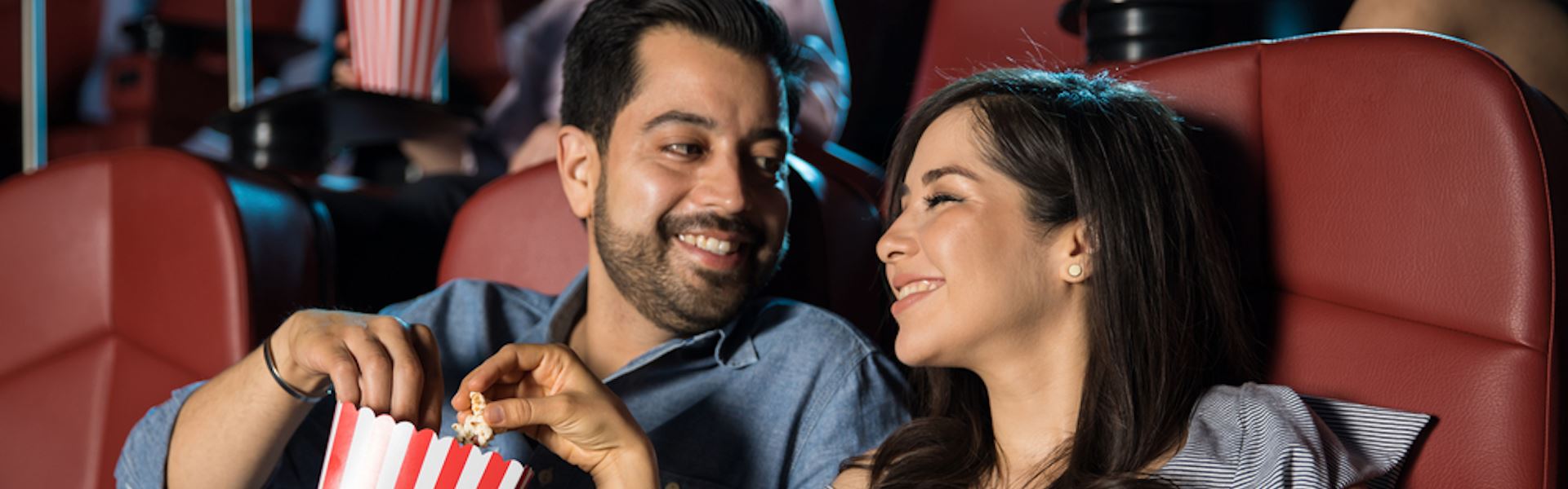 Couple at the movies eating popcorn