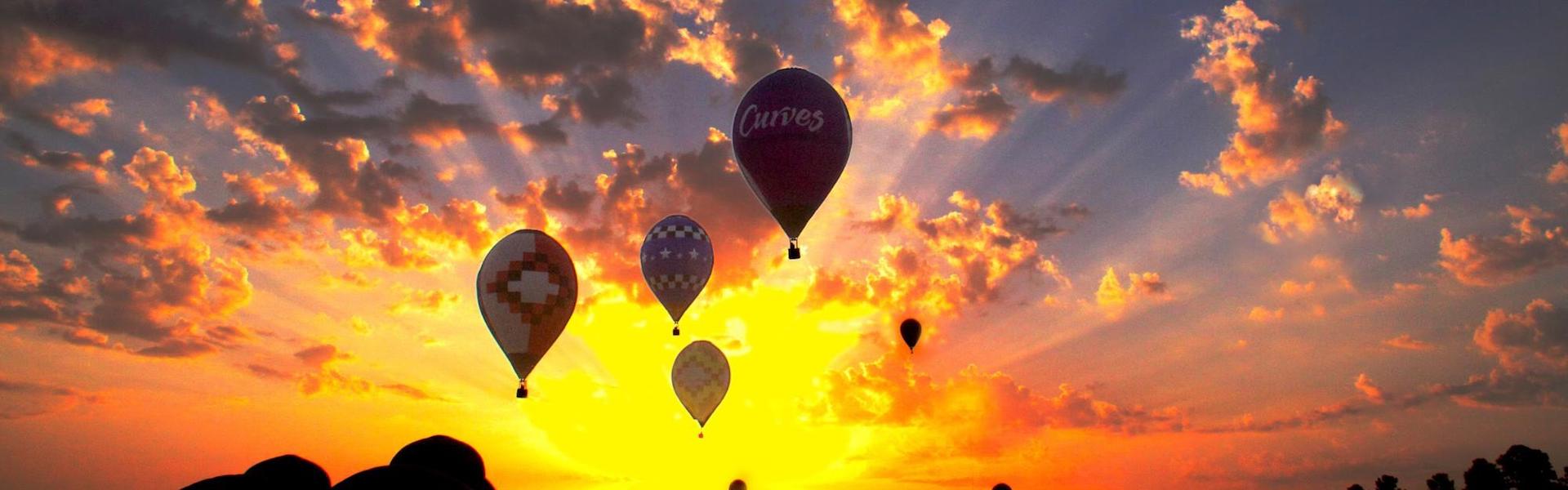 Hot air balloons at sunset in colorful sky