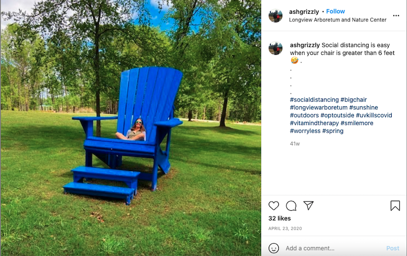 Someone sits in big blue Adirondack chair at Longview Arboretum and Nature Center