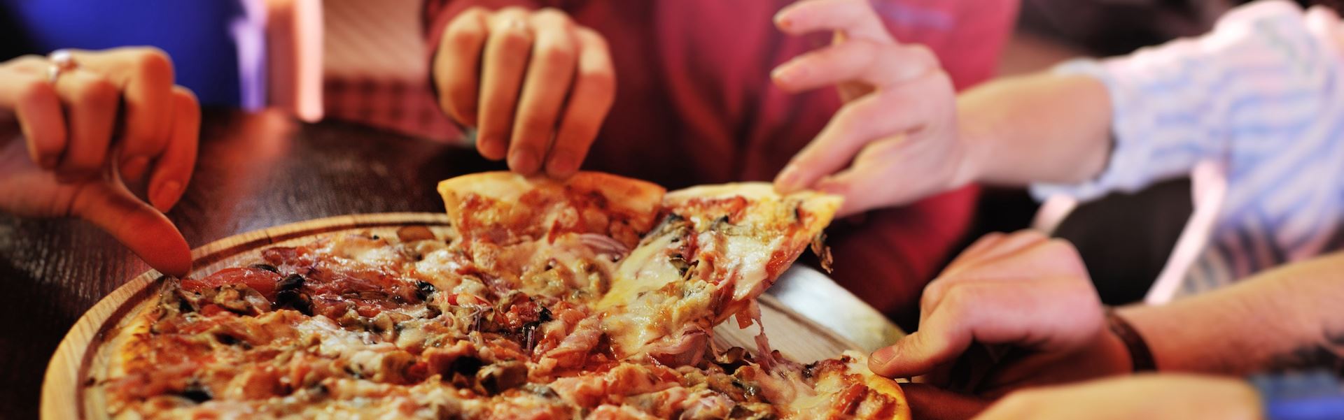 Family eats pizza Opens in new window